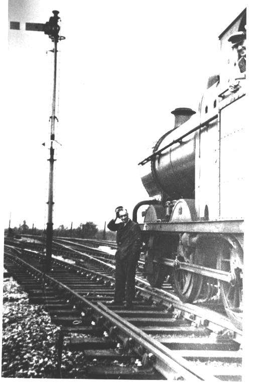 A puzzled railwayman looks at a signal in the middle of the track